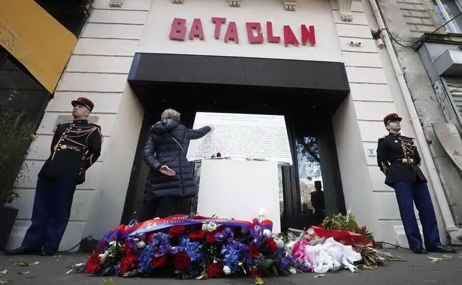 una donna tocca la targa commemorativa all ingresso del bataclan (archivio l unione sarda)