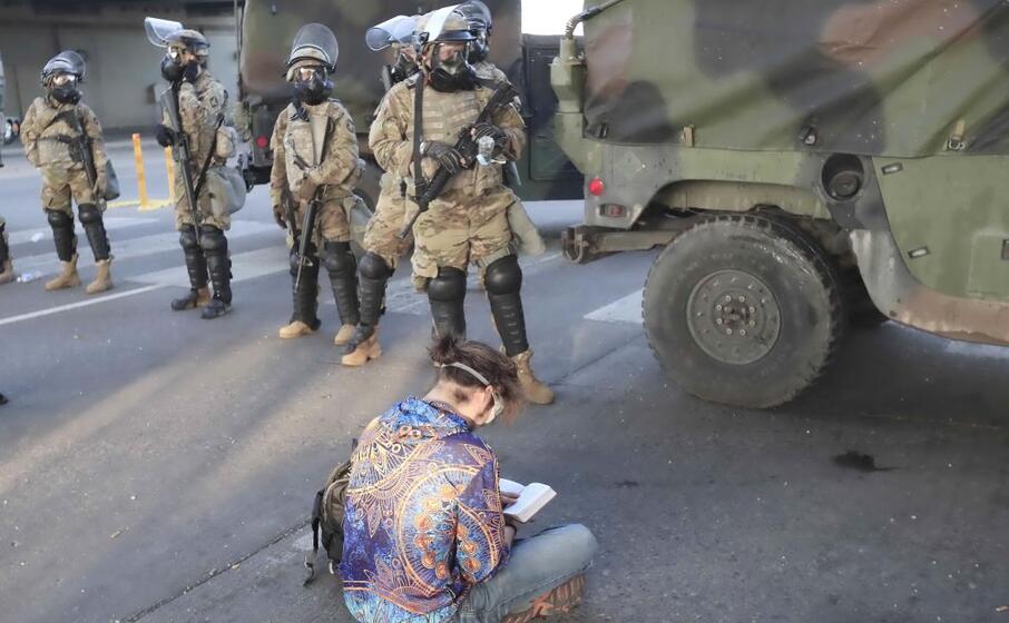 un manifestante seduto a terra davanti alla guardia nazionale (ansa maury)